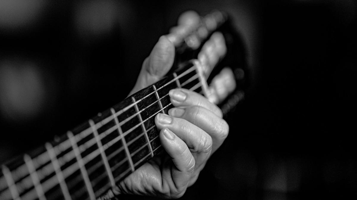 Korean artist playing guitar