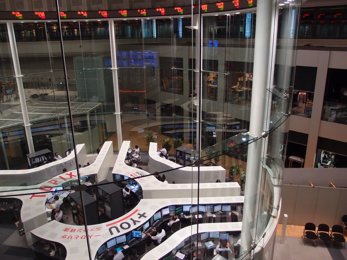 Tokyo Stock Exchange building with electronic screens and traders