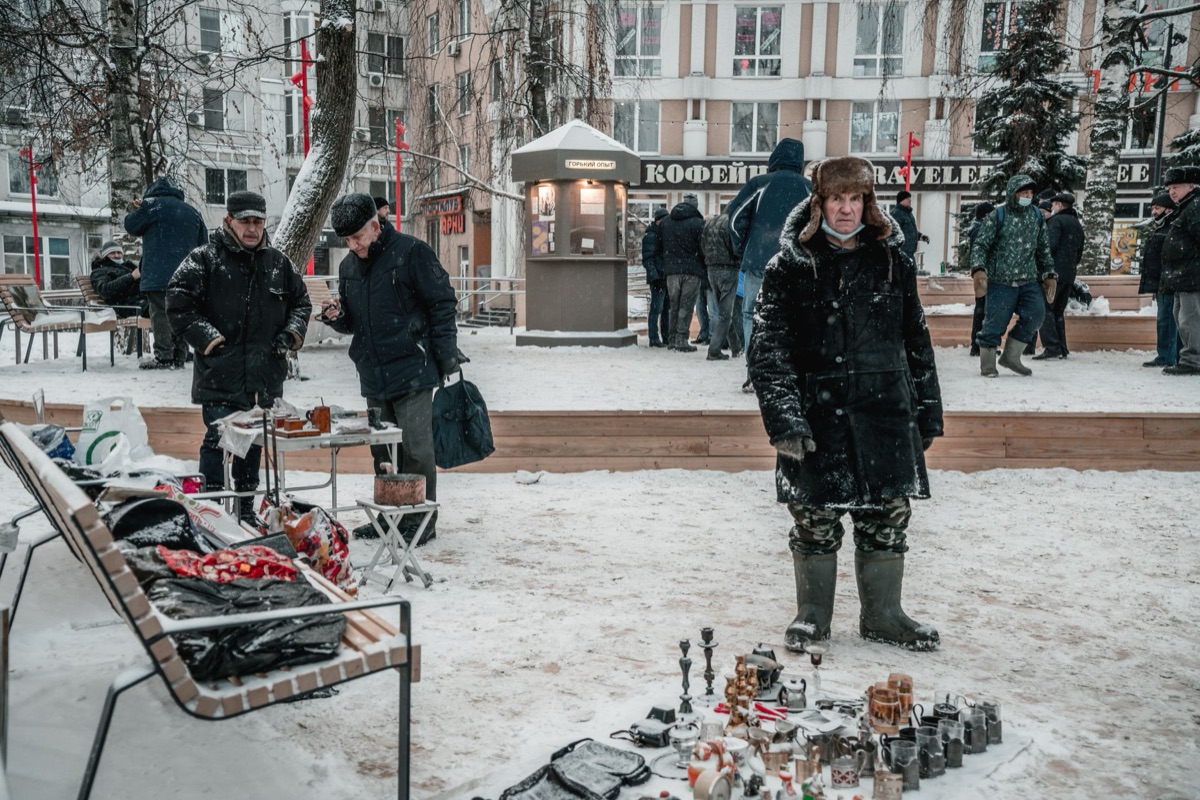 Snow-covered shrine with visitors in winter festival
