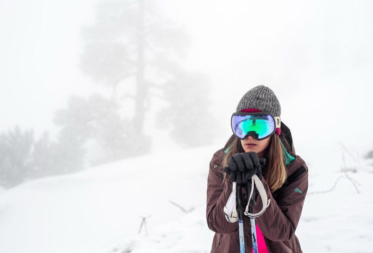 Traveler wearing thermal jacket and gloves