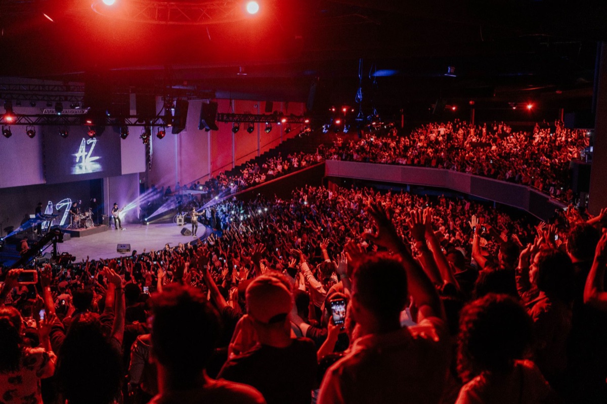 K-pop idol group performing on stage with fans